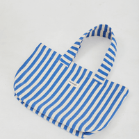  a blue and white striped tote bag laying flat on a white background