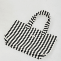 a black and white striped tote bag laying flat on a white background