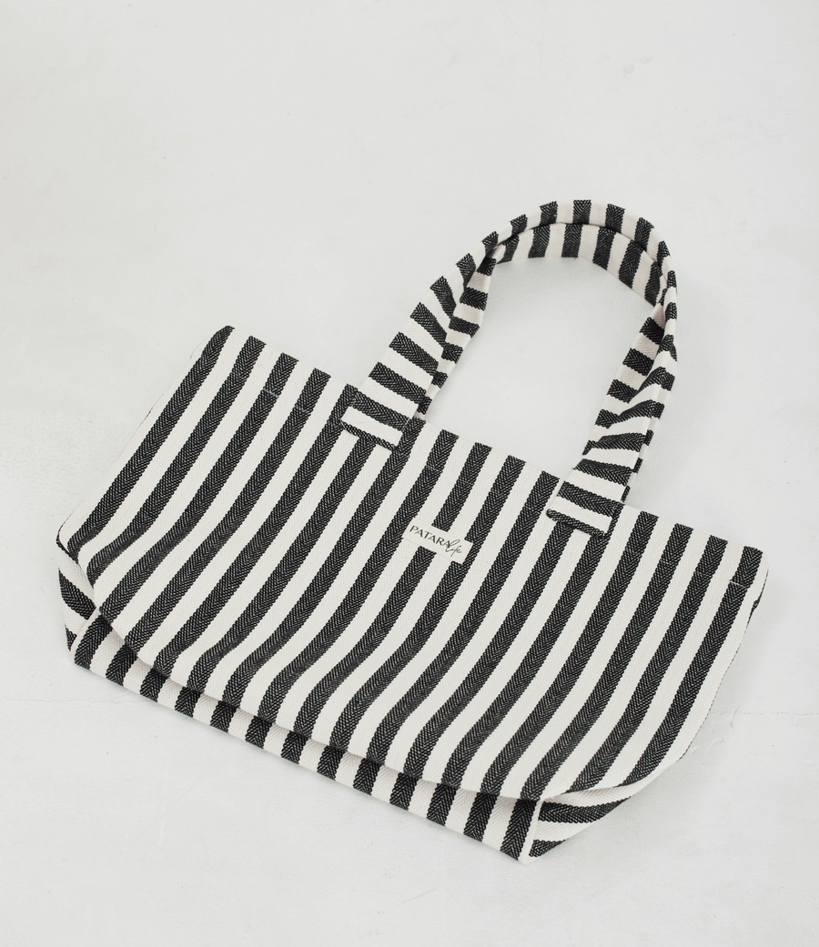 a black and white striped tote bag laying flat on a white background